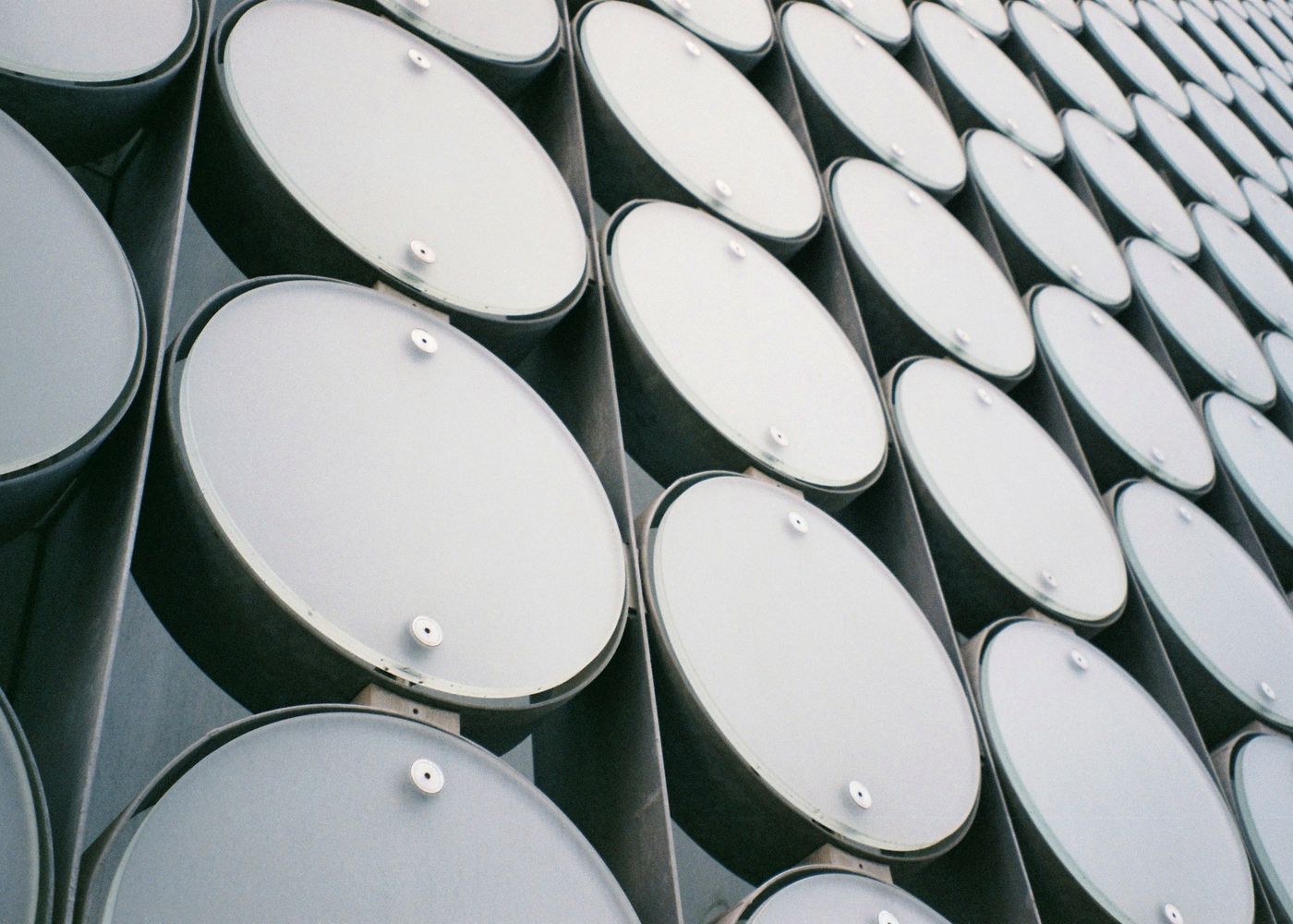 Rows of sealed lubricant and fuel drums in a distribution warehouse