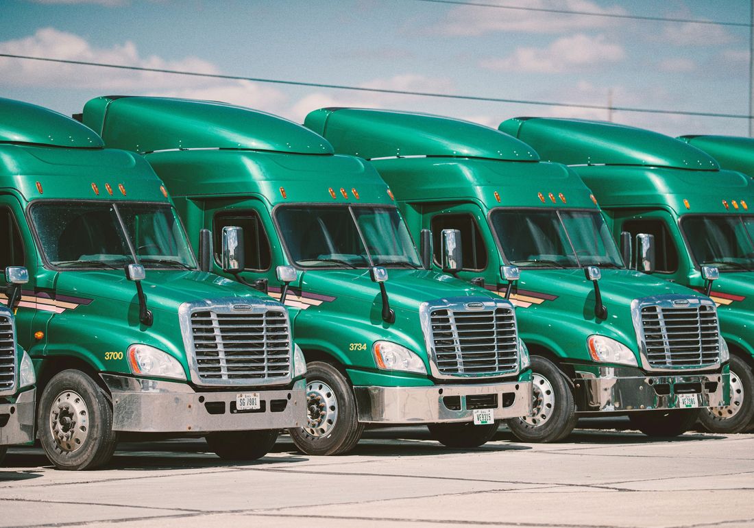 A line of heavy trucks at a transport depot