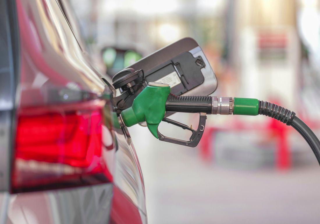 Unleaded petrol nozzle refuelling a vehicle